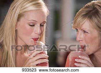 Stock Photo - young woman & 
mature woman drinking 
frozen strawberry 
smoothies. fotosearch 
- search stock 
photos, pictures, 
images, and photo 
clipart