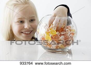 Stock Photo - blond girl reaching 
into a sweet jar. 
fotosearch - search 
stock photos, 
pictures, images, 
and photo clipart