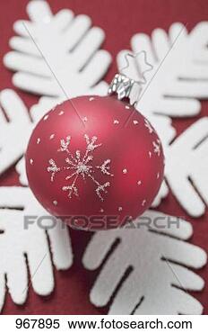 Stock Image - christmas decoration: 
christmas bauble 
on felt snowflake. 
fotosearch - search 
stock photos, 
pictures, images, 
and photo clipart