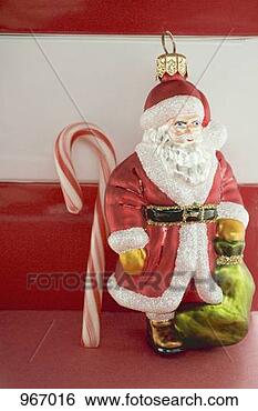 Stock Photo - christmas tree 
ornament (father 
christmas) and 
candy cane. fotosearch 
- search stock 
photos, pictures, 
images, and photo 
clipart