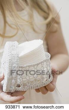 Stock Photography - girl holding crocheted 
container of cosmetic 
pads. fotosearch 
- search stock 
photos, pictures, 
images, and photo 
clipart