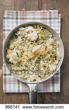 Stock Photography - pan-cooked rice 
and fish dish 
with lemon zest 
from above. fotosearch 
- search stock 
photos, pictures, 
images, and photo 
clipart