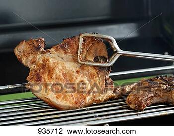 Stock Photo - turning pork chop 
with grill tongs. 
fotosearch - search 
stock photos, 
pictures, images, 
and photo clipart
