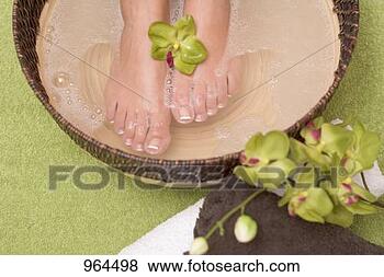 Stock Photo - woman enjoying 
a soothing foot 
bath. fotosearch 
- search stock 
photos, pictures, 
images, and photo 
clipart
