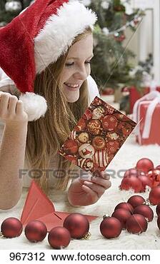 Stock Photo - woman in father 
christmas hat 
reading christmas 
card. fotosearch 
- search stock 
photos, pictures, 
images, and photo 
clipart