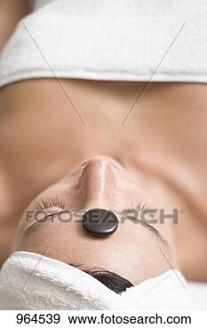 Stock Photograph - woman having hot 
stone therapy 
(healing therapy 
using stones). 
fotosearch - search 
stock photos, 
pictures, images, 
and photo clipart