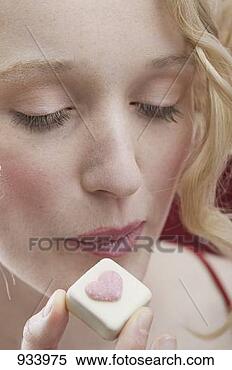 Stock Image - young woman enjoying 
a chocolate. fotosearch 
- search stock 
photos, pictures, 
images, and photo 
clipart