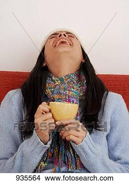 Stock Photo - young woman in 
hat and scarf 
holding a cup 
of coffee. fotosearch 
- search stock 
photos, pictures, 
images, and photo 
clipart