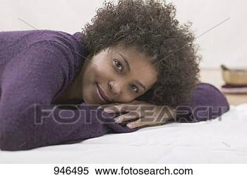 Stock Image - young woman lying 
down. fotosearch 
- search stock 
photos, pictures, 
images, and photo 
clipart