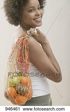 Stock Photography - young woman with 
a string bag full 
of fruit. fotosearch 
- search stock 
photos, pictures, 
images, and photo 
clipart