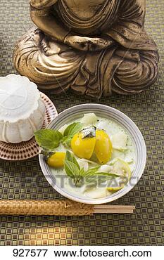 Picture - coconut soup with 
fish and thai 
aubergines in 
front of buddha. 
fotosearch - search 
stock photos, 
pictures, images, 
and photo clipart