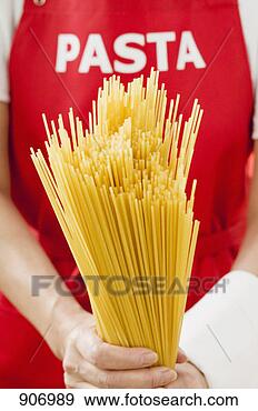 Stock Photograph - spaghetti, person 
with 'pasta' apron 
in background. 
fotosearch - search 
stock photos, 
pictures, images, 
and photo clipart