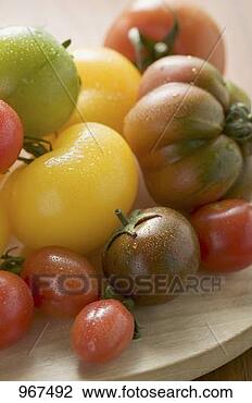 Stock Photo - various types 
of tomatoes on 
wooden plate (detail). 
fotosearch - search 
stock photos, 
pictures, images, 
and photo clipart