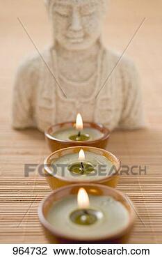 Stock Photo - three windlights 
in front of buddha 
statue on bamboo 
mat. fotosearch 
- search stock 
photos, pictures, 
images, and photo 
clipart