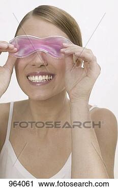 Stock Photography - woman with a cooling 
eye mask. fotosearch 
- search stock 
photos, pictures, 
images, and photo 
clipart