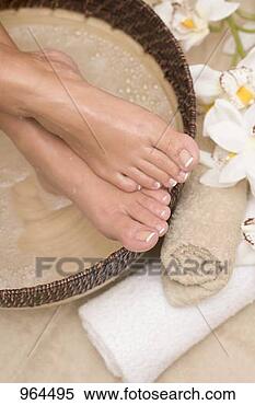 Stock Image - woman enjoying 
a soothing foot 
bath. fotosearch 
- search stock 
photos, pictures, 
images, and photo 
clipart