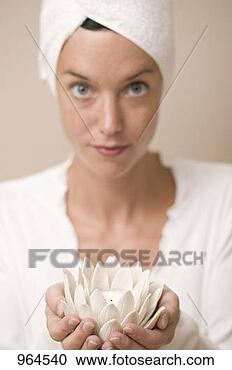 Stock Photography - woman holding 
water lily votive. 
fotosearch - search 
stock photos, 
pictures, images, 
and photo clipart