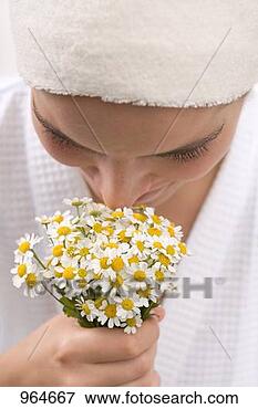 Picture - woman smelling 
chamomile flowers. 
fotosearch - search 
stock photos, 
pictures, images, 
and photo clipart