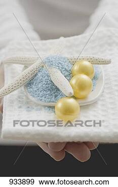 Stock Photograph - young woman holding 
bath salts & bath 
pearls with starfish. 
fotosearch - search 
stock photos, 
pictures, images, 
and photo clipart