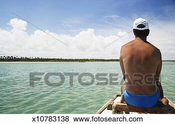 Stock Photo - mature man sitting 
in boat in ocean, 
looking at view, 
rear view. fotosearch 
- search stock 
photos, pictures, 
images, and photo 
clipart