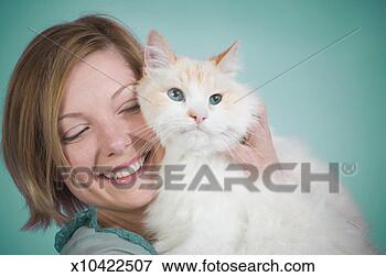 Picture - mid adult woman 
hugging cat and 
smiling, close-up. 
fotosearch - search 
stock photos, 
pictures, images, 
and photo clipart