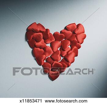 Stock Photography - small red fabric 
padded hearts 
arranged in larger 
heart shape. fotosearch 
- search stock 
photos, pictures, 
images, and photo 
clipart