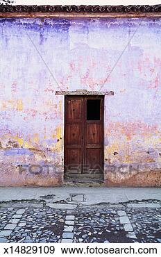 Stock Photograph - wooden doors in 
painted weathered 
wall. fotosearch 
- search stock 
photos, pictures, 
images, and photo 
clipart