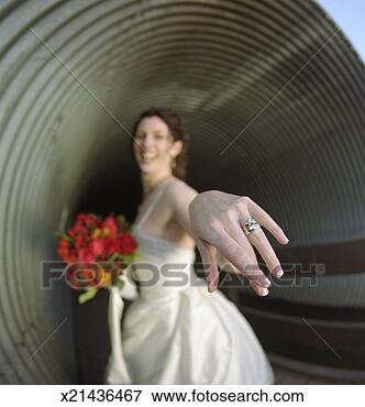 Picture - bride showing 
wedding ring, 
smiling (focus 
on wedding ring). 
fotosearch - search 
stock photos, 
pictures, images, 
and photo clipart