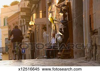 Stock Image - italy, basilicata, 
matera, senior 
man sitting in 
doorway. fotosearch 
- search stock 
photos, pictures, 
images, and photo 
clipart