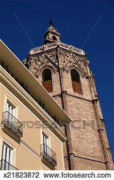 Stock Photo - spain, valencia, 
valencia cathedral 
bell tower by 
apartment building. 
fotosearch - search 
stock photos, 
pictures, images, 
and photo clipart