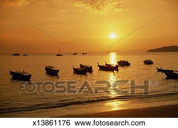 Stock Photo - thailand, krabi, 
koh mor island, 
ao nang beach, 
fishing boats, 
sunset. fotosearch 
- search stock 
photos, pictures, 
images, and photo 
clipart