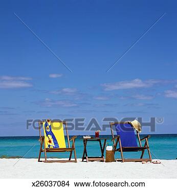 Stock Photo - usa, florida, 
miami beach, two 
beach chairs with 
table and drink. 
fotosearch - search 
stock photos, 
pictures, images, 
and photo clipart