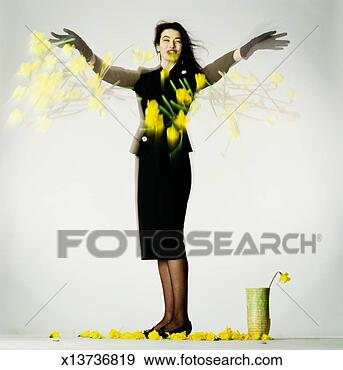 Stock Photograph - woman in black 
suit throwing 
daffodils, arms 
outstretched, 
smiling. fotosearch 
- search stock 
photos, pictures, 
images, and photo 
clipart