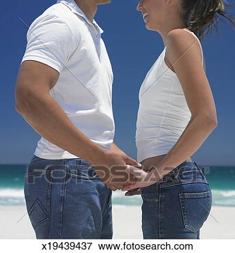 Picture - young couple face 
to face on beach, 
holding hands, 
profile, close-up. 
fotosearch - search 
stock photos, 
pictures, images, 
and photo clipart