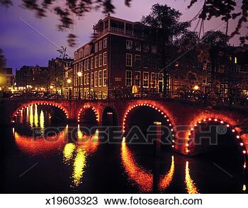 Stock Photo - holland, amsterdam, 
lighted bridge 
on amsterdam canal. 
fotosearch - search 
stock photos, 
pictures, images, 
and photo clipart