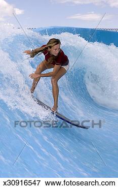 Picture - mature woman surfing 
on wave in wave 
machine. fotosearch 
- search stock 
photos, pictures, 
images, and photo 
clipart