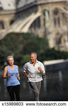 Stock Photo - senior couple 
jogging (focus 
on couple). fotosearch 
- search stock 
photos, pictures, 
images, and photo 
clipart
