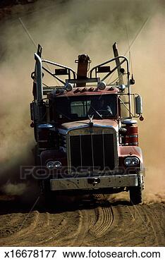 Picture - trucker driving 
log hauling truck. 
fotosearch - search 
stock photos, 
pictures, images, 
and photo clipart