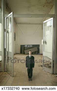 Stock Photography - businessman standing 
at attention in 
abandoned office 
interior. fotosearch 
- search stock 
photos, pictures, 
images, and photo 
clipart