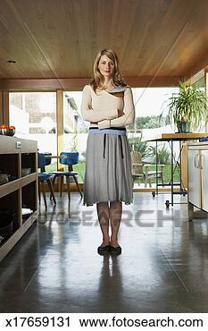 Stock Photography - mid adult woman 
standing in kitchen, 
portrait. fotosearch 
- search stock 
photos, pictures, 
images, and photo 
clipart