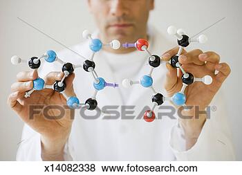 Stock Photo - scientist holding 
molecule model, 
mid section, focus 
on foreground. 
fotosearch - search 
stock photos, 
pictures, images, 
and photo clipart