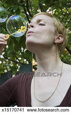 Stock Photography - mid adult man 
playing with bubble-wand. 
fotosearch - search 
stock photos, 
pictures, images, 
and photo clipart