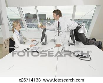 Stock Photo - business man kneeling 
on desk, giving 
present to business 
woman. fotosearch 
- search stock 
photos, pictures, 
images, and photo 
clipart