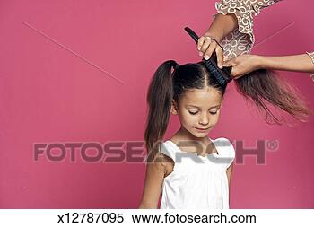 Stock Image - girl (4-5) having 
hair brushed by 
woman. fotosearch 
- search stock 
photos, pictures, 
images, and photo 
clipart