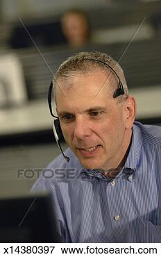 Picture - mature man wearing 
headset at work. 
fotosearch - search 
stock photos, 
pictures, images, 
and photo clipart