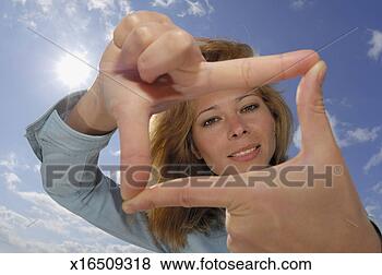 Stock Photo - young woman against 
sky with sun, 
 forming finger 
frame,  portrait. 
fotosearch - search 
stock photos, 
pictures, images, 
and photo clipart
