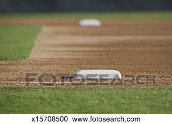 Stock Photography - baseball diamond 
(focus on base 
in foreground). 
fotosearch - search 
stock photos, 
pictures, images, 
and photo clipart