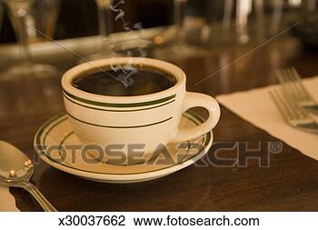 Stock Photo - cup of coffee 
on diner countertop 
(focus on coffee 
cup). fotosearch 
- search stock 
photos, pictures, 
images, and photo 
clipart