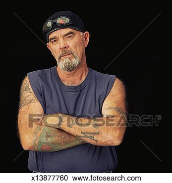 Stock Photography - mature man with 
tattooed arms, 
arms crossed, 
portrait. fotosearch 
- search stock 
photos, pictures, 
images, and photo 
clipart