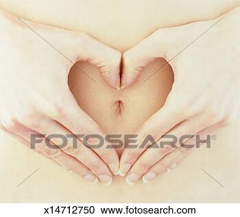 Stock Photography - woman making heart 
shape with hands 
around belly button, 
close-up. fotosearch 
- search stock 
photos, pictures, 
images, and photo 
clipart
